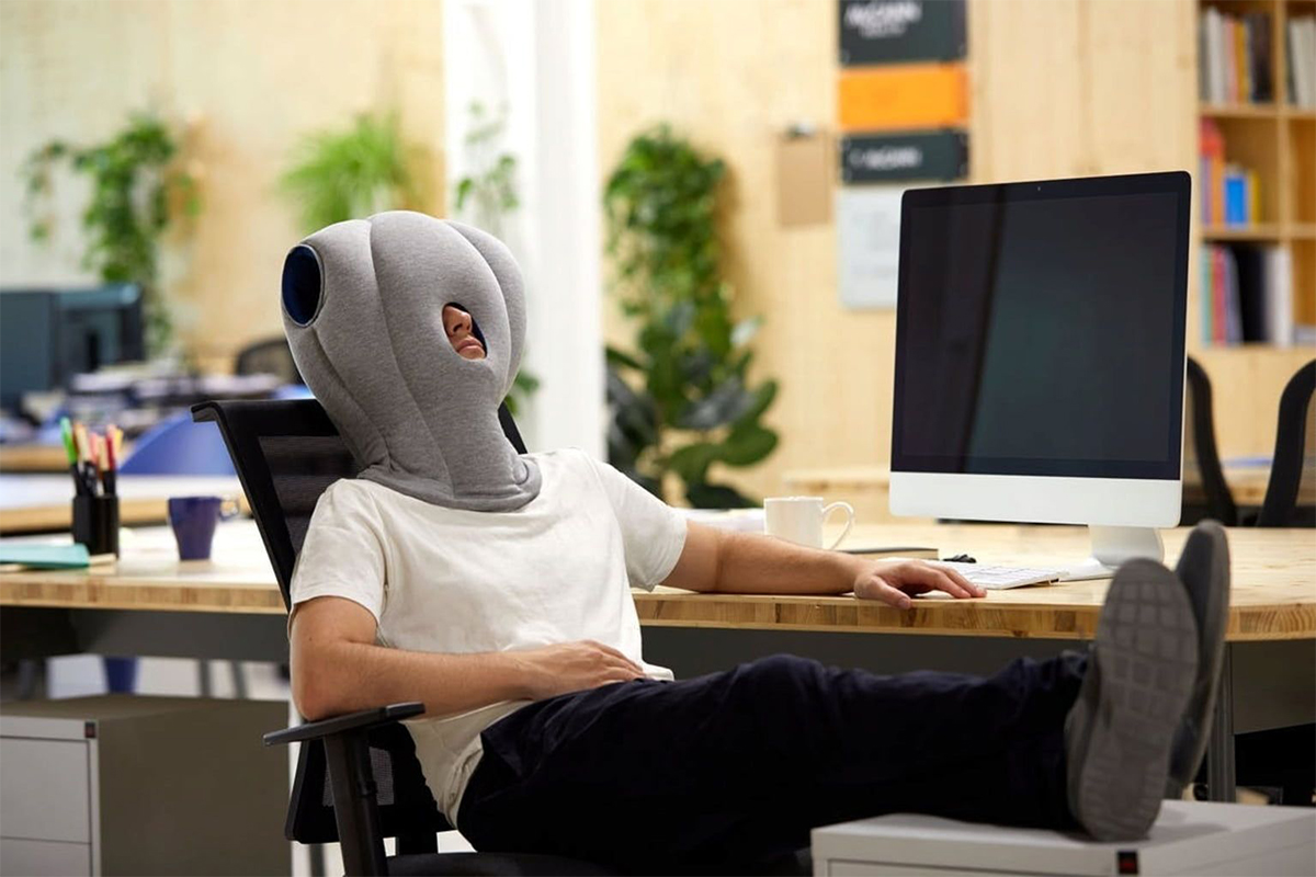 Man with pillow on head.