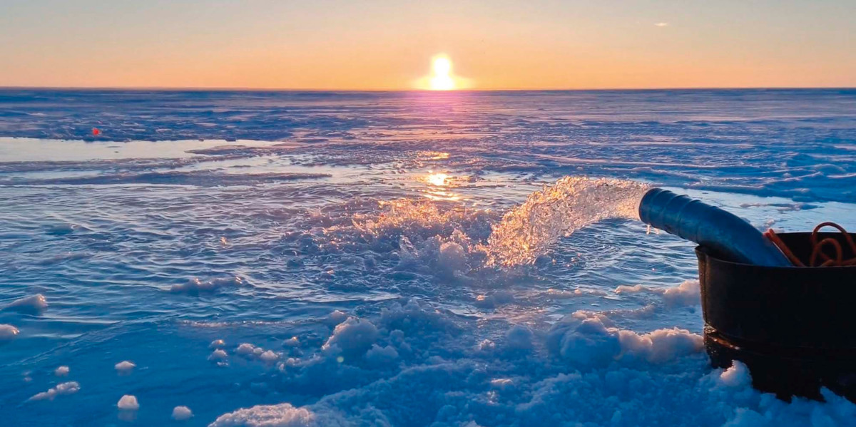 Photograph of water being pumped from underneath the ice onto its surface