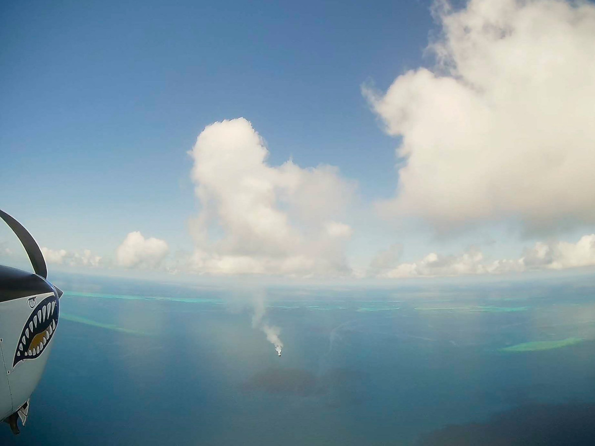 A photo of marine cloud brightening in progress over the Great Barrier Reef, with salt crystals from aerosolised seawater rising up to the clouds