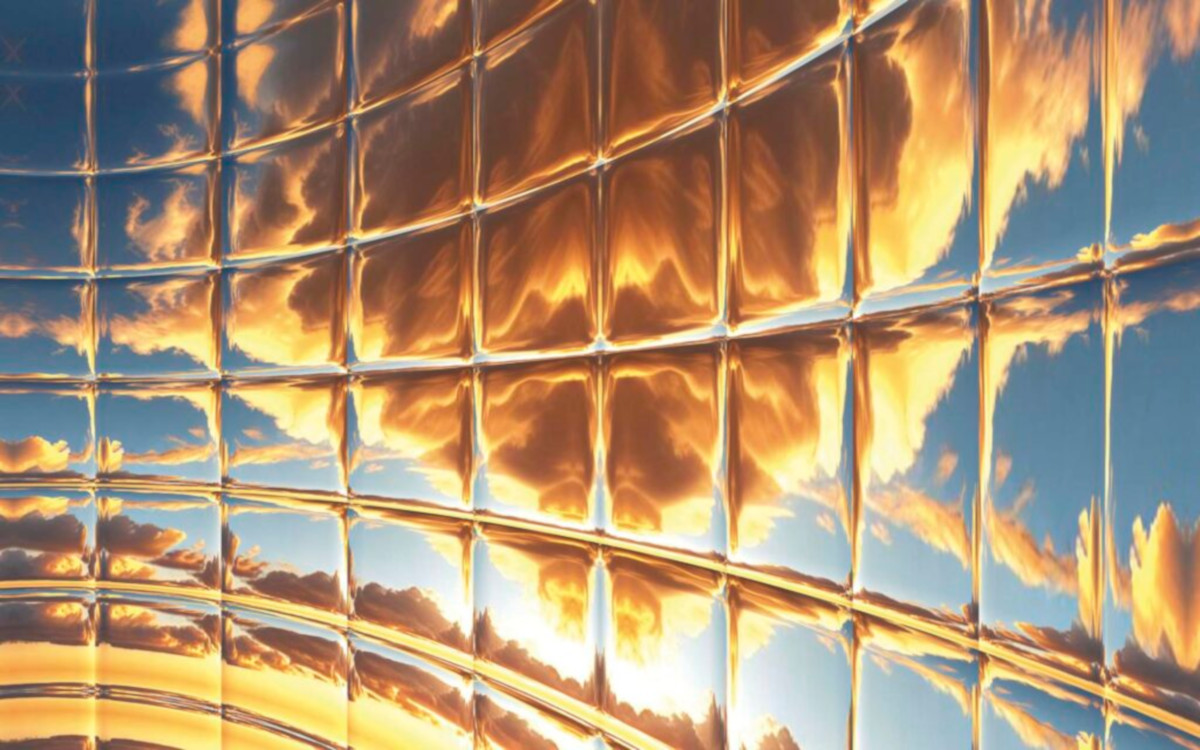Reflection of sunset-coloured clouds on a shiny metal surface