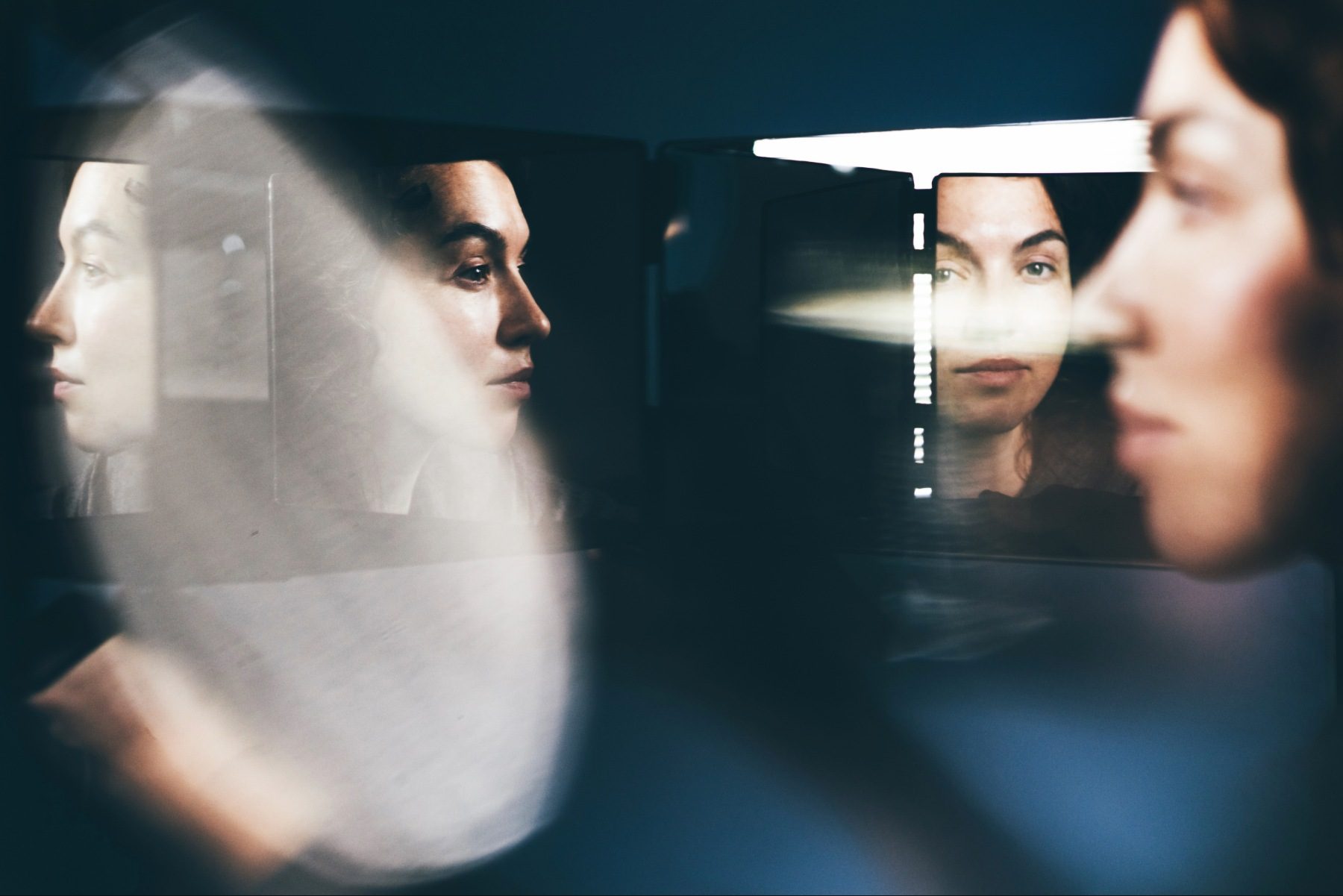 Woman's face reflected in several mirrors