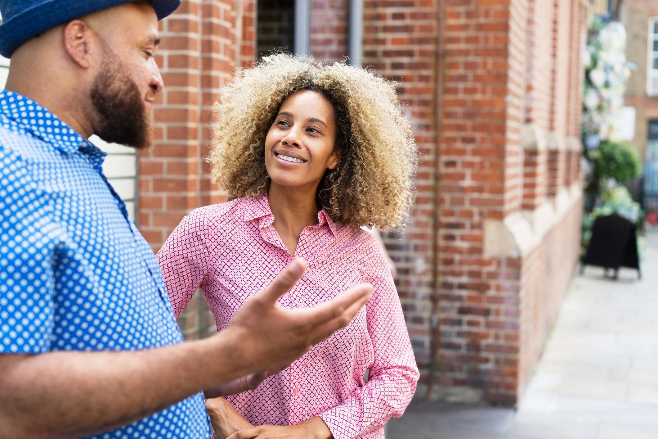 Woman and man talking outside.