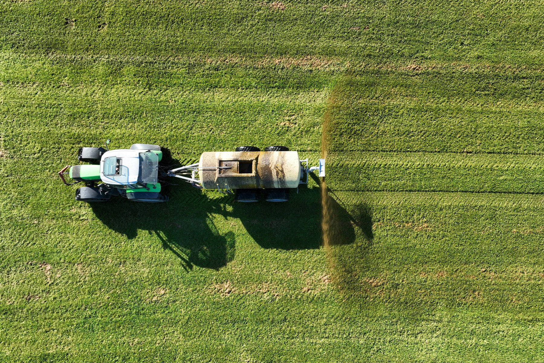 Tanker spreading liquid manure on a field