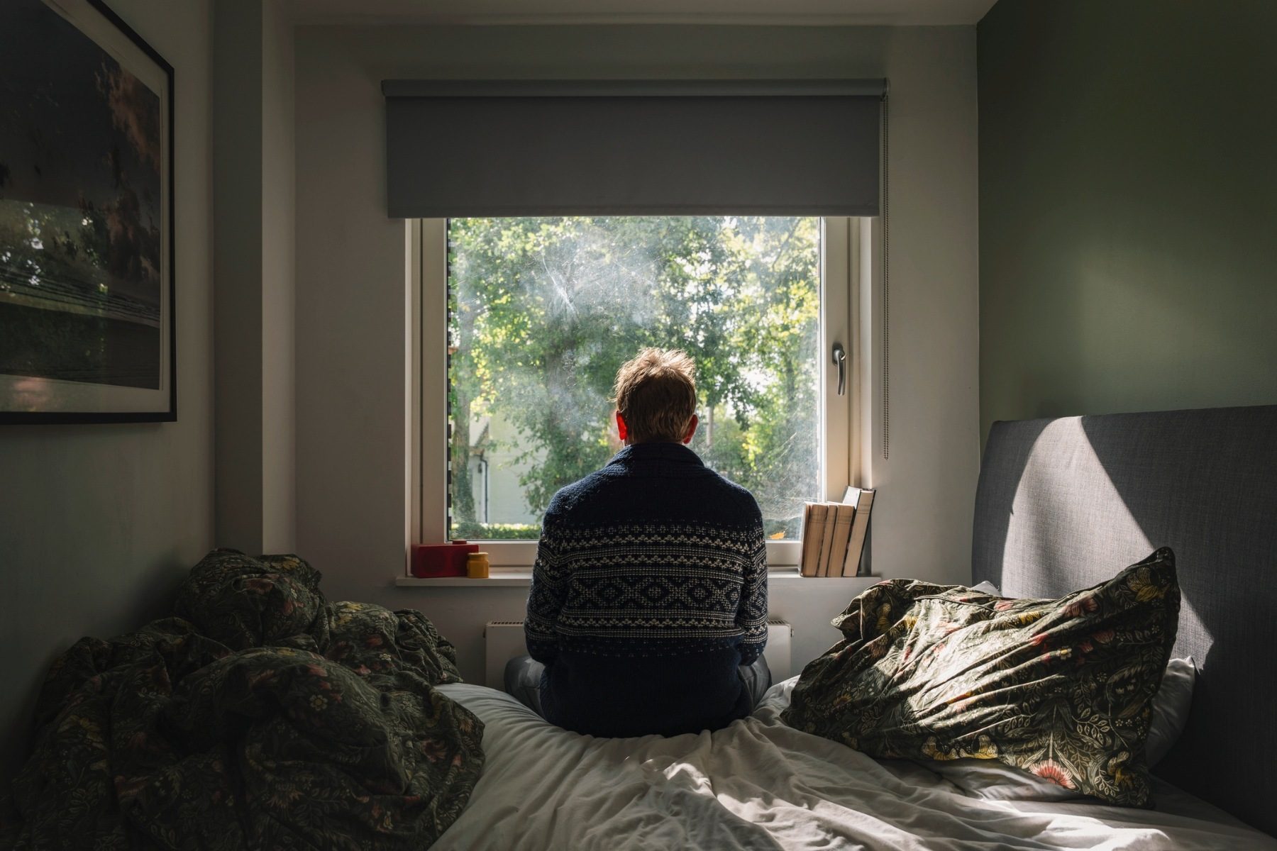 Man staring out of window