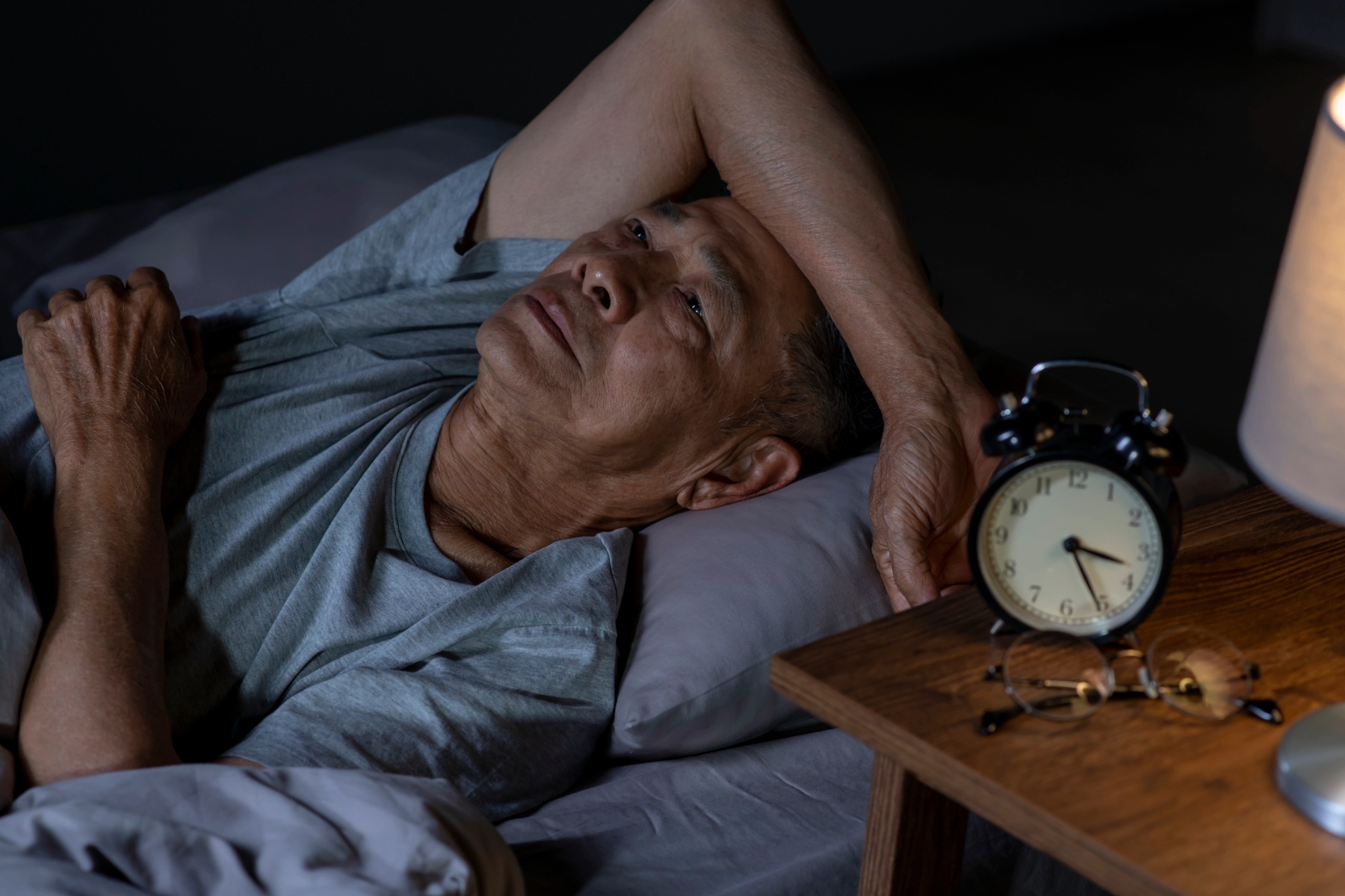 Man in bed, unable to sleep
