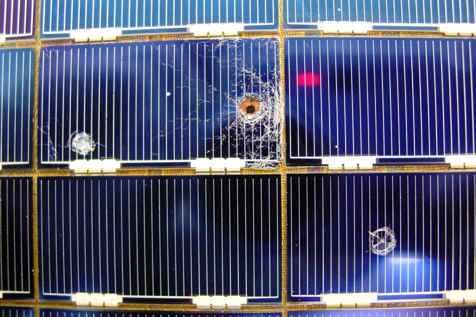 Solar panel with three large craters in the surface