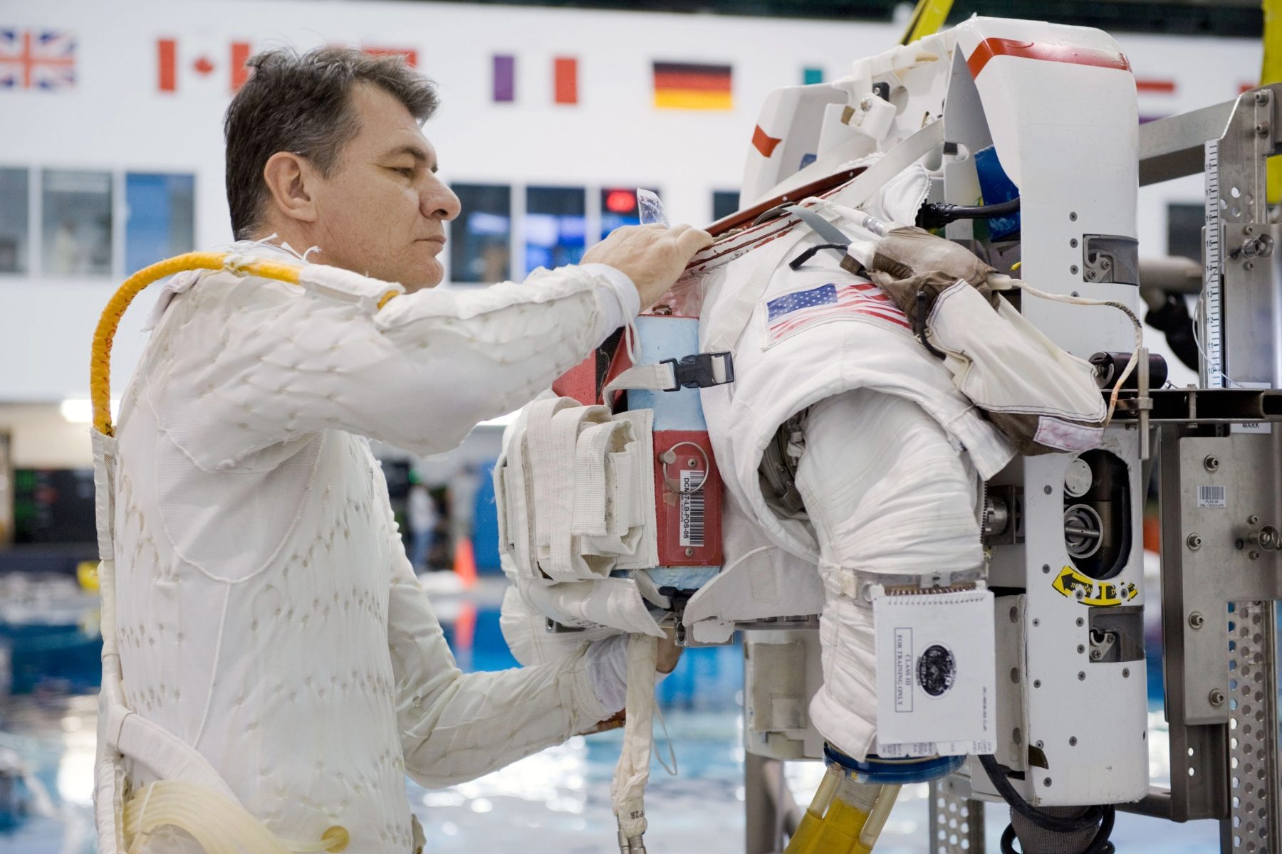 Paolo Nespoli in a cooling suit fixing his spacesuit
