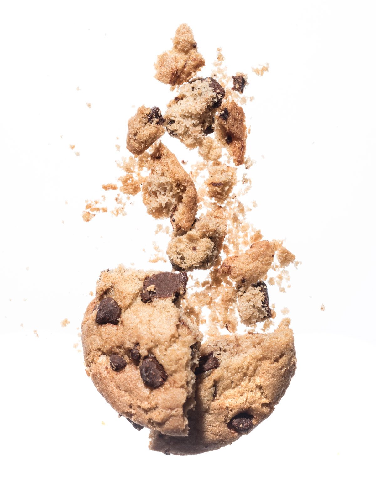 Broken chocolate chip cookie on white background