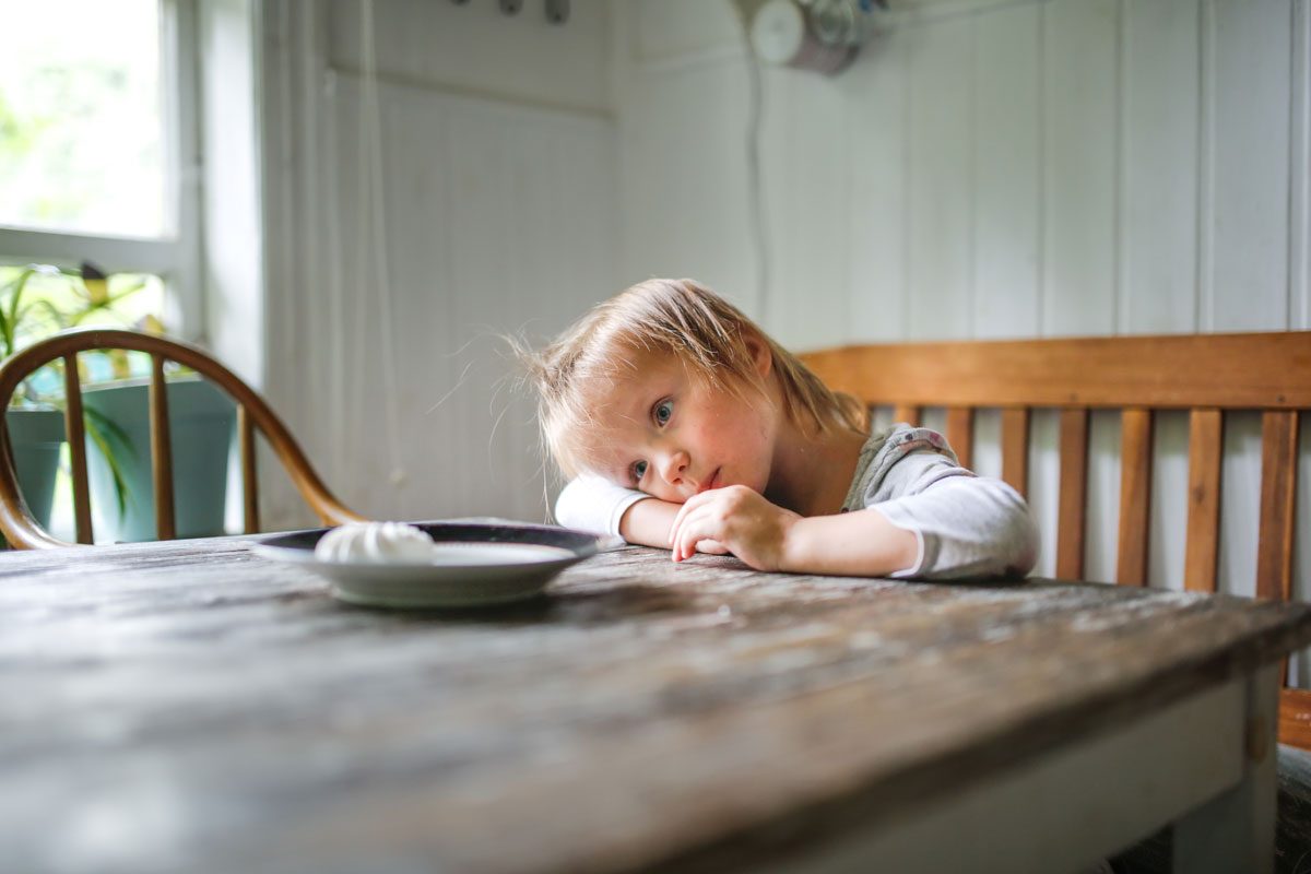 child trying to resist a sweet treat.