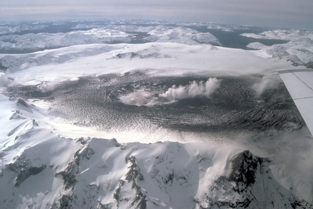 Volcano with thick clouds.