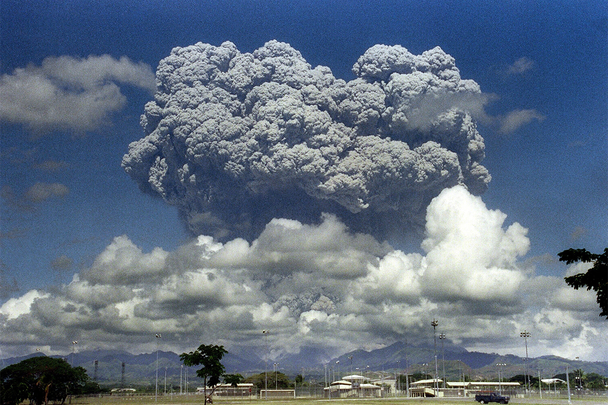 Huge black plume of smoke over volcano.