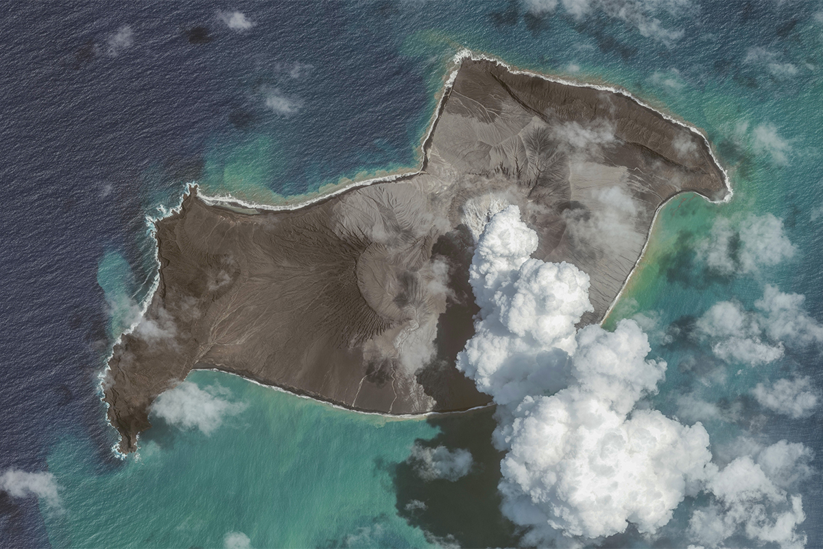 Aerial view of green blue water and one large island.