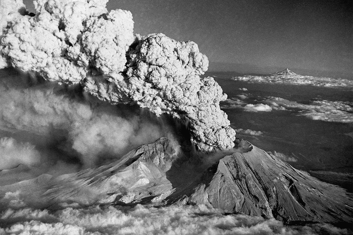 Black and white image of huge volcano eruption thick smoke.