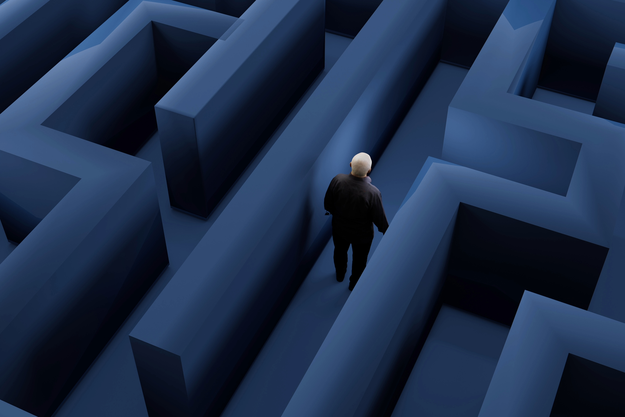 Person walking through a dark blue maze, symbolising confusion, memory loss and the challenges of navigating dementia