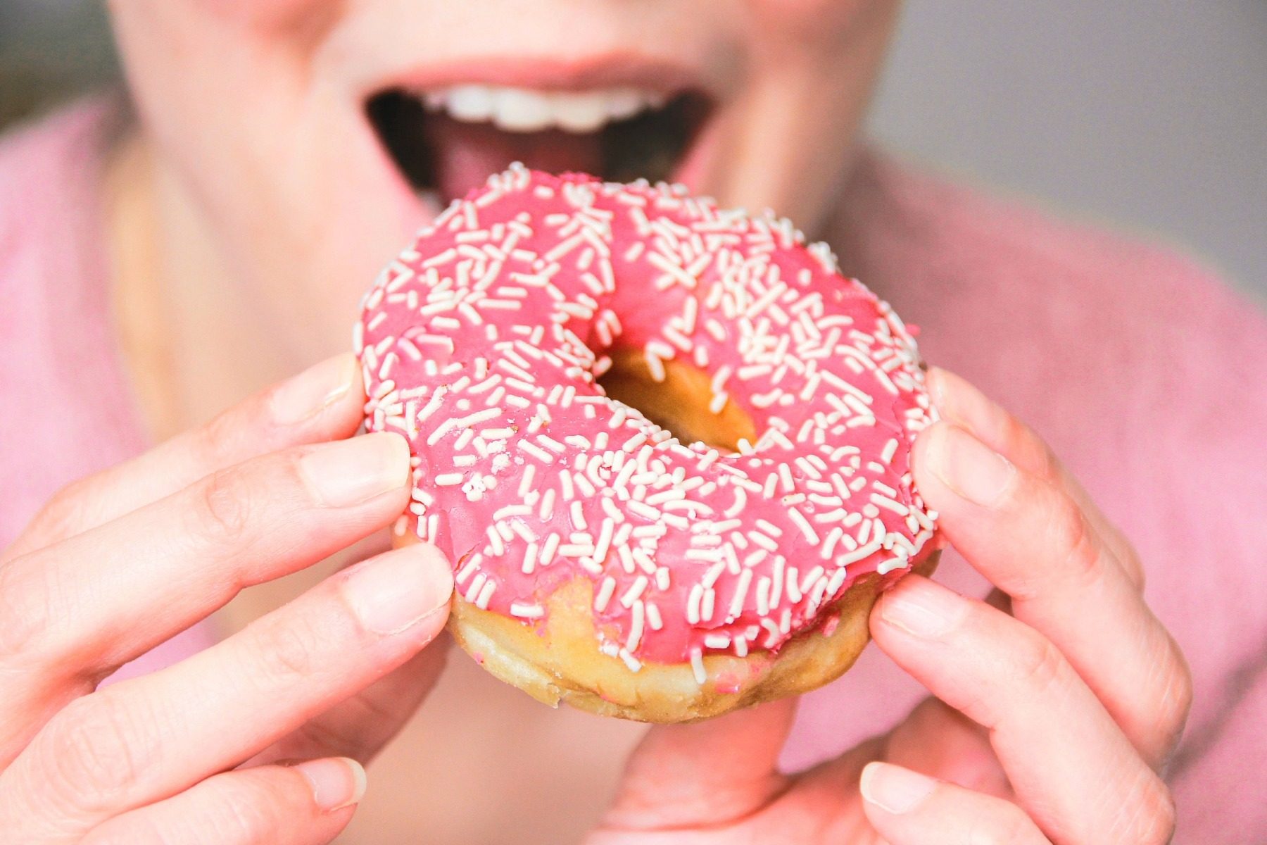 Person eating a donut