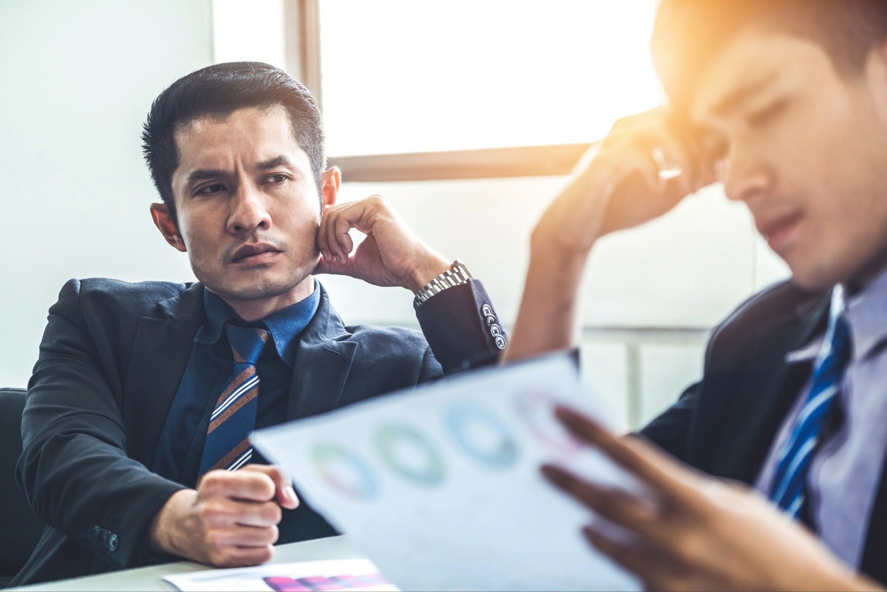 Man looking thoughfully at worker
