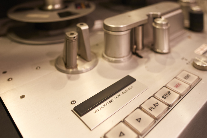 
Close-up of vintage multichannel tape recorder with control buttons and reels in a studio