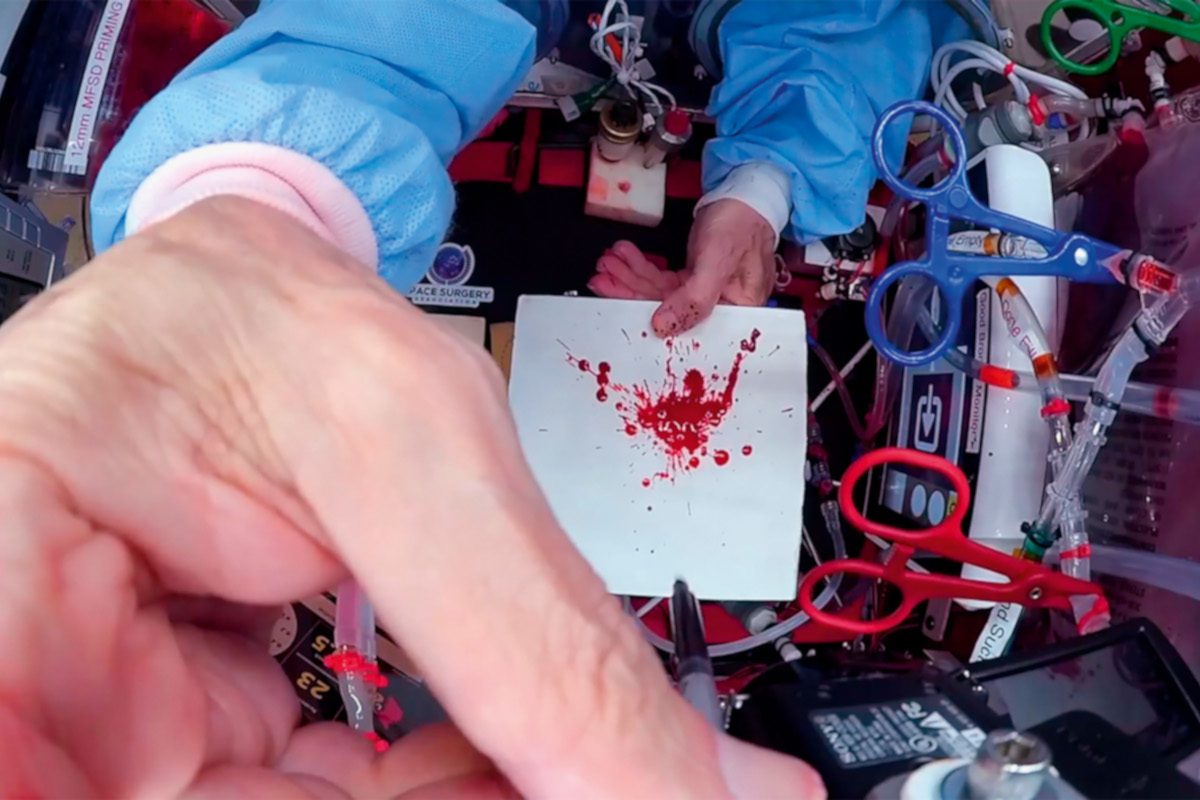 Photo of fake blood spatter on a piece of paper in microgravity
